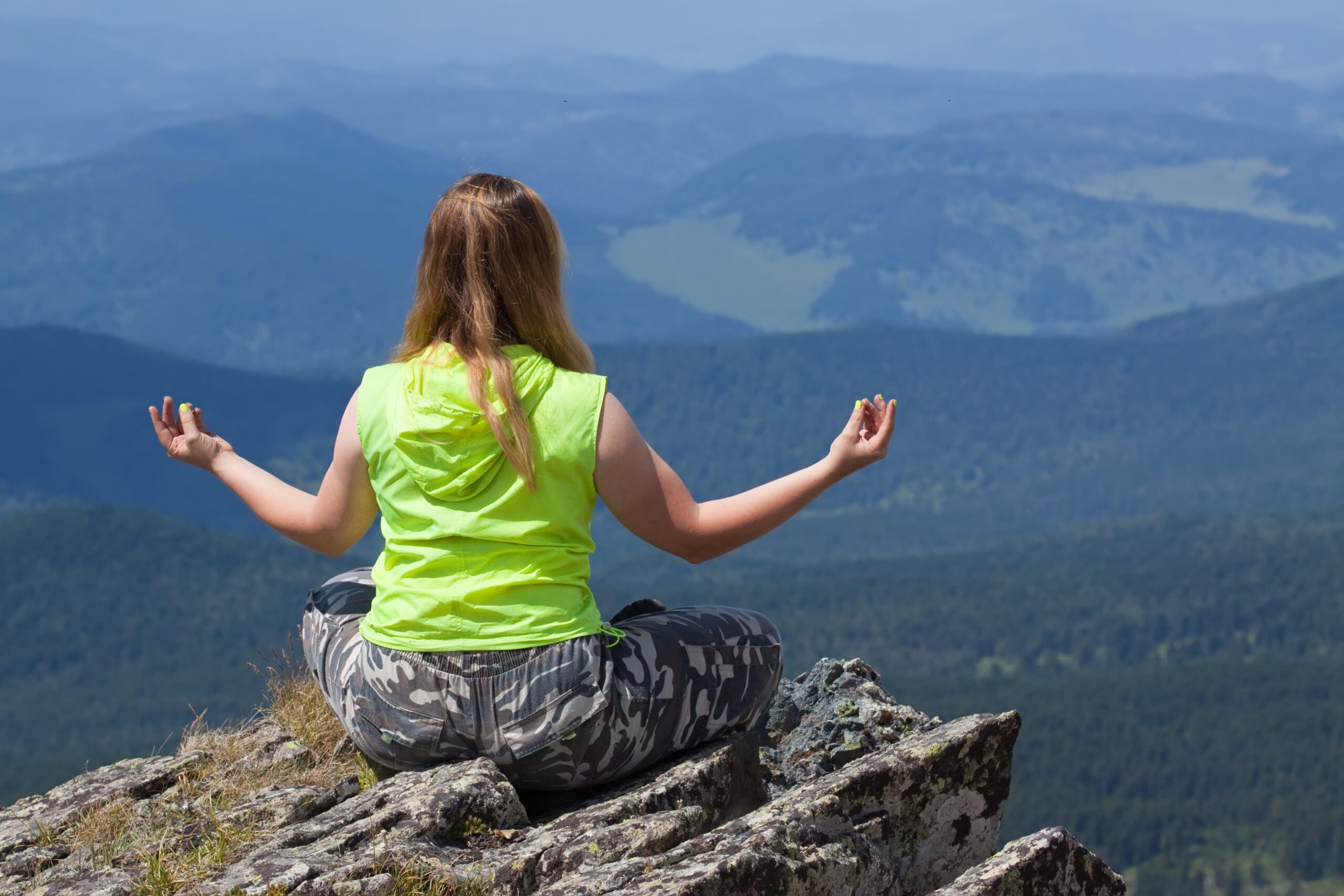 Woman doing yoga at mountain